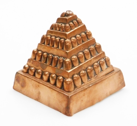 A Temple and Crook Victorian copper jelly mould, pyramid design, on a square base, stamp to Temple and Crook Ironmongers, number 568 with registered number 332529, 11.5cm high, 12cm wide.