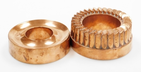 Two Victorian ring jelly moulds, to include one of plain design with inset border, 4cm high, 15cm wide, and another of fluted column design by Benham and Froud, numbered 462 with cross and orb symbol, 7cm high, 17cm wide. (2)