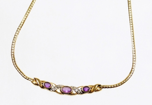 A 9ct gold pendant and chain, the pendant section set with three oval amethysts, in cross detailing set with tiny diamonds, on fine link chain, 43cm long overall, 6.9g all in.