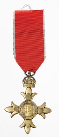 An OBE Badge (civil), with ribbon.