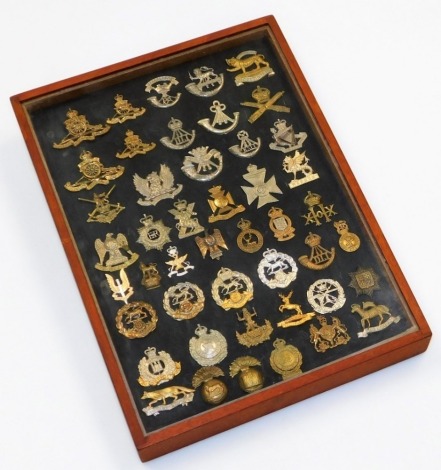 A collection of military cap badges, including some reproductions, including Royal Hampshire, London Cyclists, Rifle Corps, Ayrshire Yeomanry, Royal Artillery, Leicestershire Rgt, etc. (46) cased.