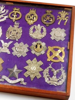 A collection of military cap badges, including some reproductions, Lorats Scouts, Highlanders, Cameroonians Highland Regt, Camerian Highlander, etc., 30, cased. - 2