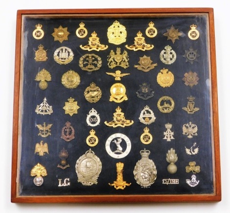 A collection of military cap badges, to include some reproductions, Worcestershire Regt, The Royal Irish Regt, etc. (50, cased)