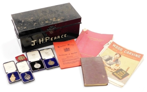 A group of army ephemera, to include the regular army certificate of service, The Woodworkers Pocket Book, Forty Power Tools You Can Make, books on wood carving, a silver plated armed medallion for 1925, a medallion of the Norfolk Regiment Heneker 1929 fo