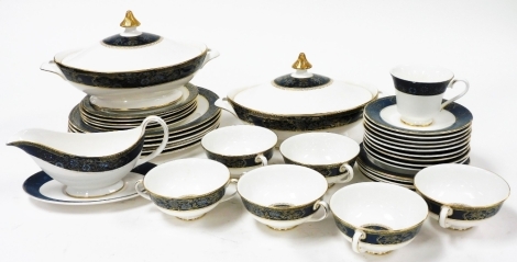 A Royal Doulton Carlisle pattern part dinner service, comprising two tureens, six two handled cups and sauces, single teacup, side plates, dinner plates, bread plates and a gravy boat and saucer.