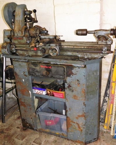 A Myford lathe and stand, together with various cutting tools. Buyer Note: WARNING! This lot contains untested or unsafe electrical items. It is supplied for scrap or reconditioning only. TRADE ONLY