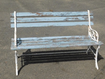 A cast metal garden bench, with blue painted wooden slats and white painted ends, 72cm high, 122cm wide, 42cm deep.