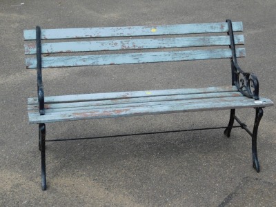 A cast metal garden bench, with blue painted wooden slats and black painted ends, 72cm high, 122cm wide, 42cm deep.