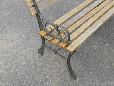 A slatted garden bench, with metal scroll support ends, previously stained, 74cm high, 120cm wide, 45cm deep. - 2