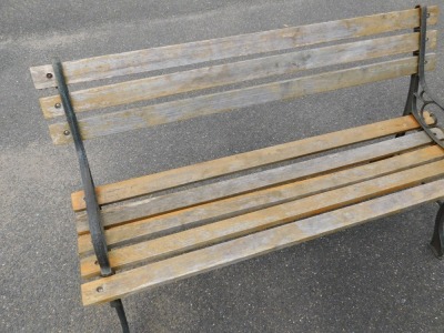 A slatted garden bench, with metal scroll support ends, previously stained, 74cm high, 120cm wide, 45cm deep. - 3