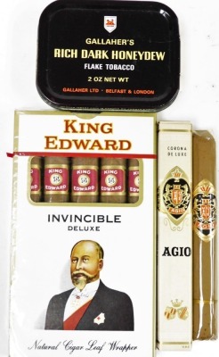 A box of King Edward invincible deluxe cigars, in original plastic wrapper, Gallagher unopened flake tin tobacco and a boxed Agio cigar. (a quantity)