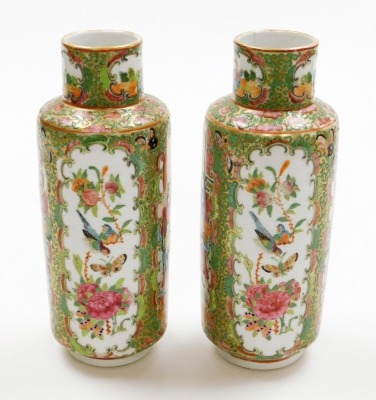 A pair of Chinese Canton vases, each with panels of figures, birds and flowers on a gilt and green flowered ground, 19thC, 26cm high. - 18