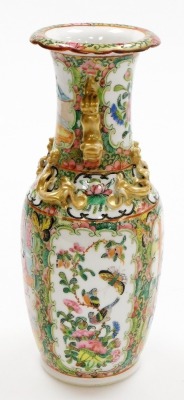 A 19thC Chinese Canton porcelain baluster vase, decorated with panels of figures at leisure and opposing panels of flowers and butterflies, applied gilt chilin to the shoulders, dog of fo handles and frilled neck, 25cm high. - 16