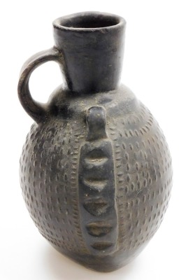 A Chinese pottery ovoid ewer with single handle and relief decorated body, 19thC or earlier, 20cm high. - 18