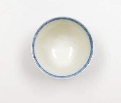 A Japanese porcelain tea bowl, in imitation of a Kangxi original, with everted rim decorated in blue and white depicting female musicians and flowers, signed Zoshuntei Sampo sei to base and collection reference number 14, 19thC, 8cm high. (AF) - 5