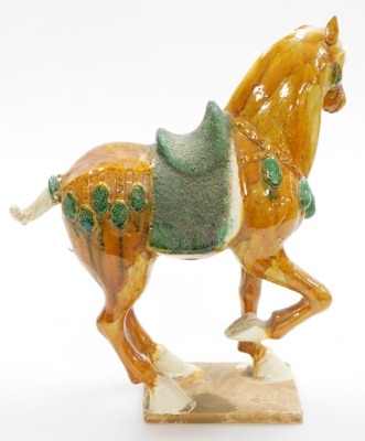 A Chinese terracotta horse in Tang style, decorated in green and orange glaze on a rectangular base, 40cm high. - 3