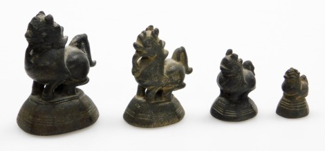 A set of four graduated Chinese bronze opium weights modelled as Dogs of Fo, the largest 7cm high, the smallest 2½cm high. (4)