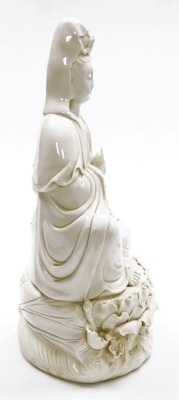 A Chinese blanc de chine figure of Guan Yin seated on a lotus and wave base, impressed mark to the rear, 46cm high. (AF) - 12