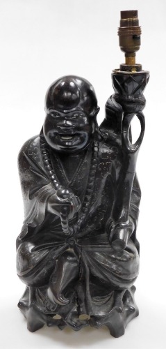 A Chinese teak figure of seated Putai with beads and staff, the body profusely inlaid with silver wire designs, converted to a table lamp, 46cm high. (AF)