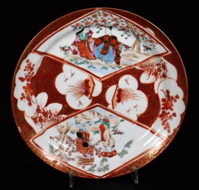 A 19thC Japanese Hirado plate, decorated in overglaze colours with panels of figures and flowers with gilt highlights, predominately in orange, the underside marked Mikawachi seizo, 18cm diameter.