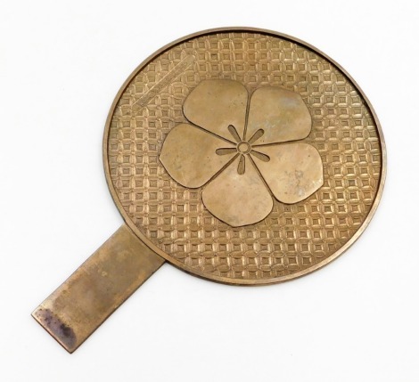 A Chinese bronze mirror, with five petal prunus blossom mon on a relief diaper background containing a cartouche with lengthy inscription,19thC, 34cm high, 24cm diameter.