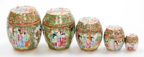 A graduated set of 19thC Chinese Canton porcelain jars and covers, decorated with panels of figures, birds and flora, from 10cm high down to 4cm high.