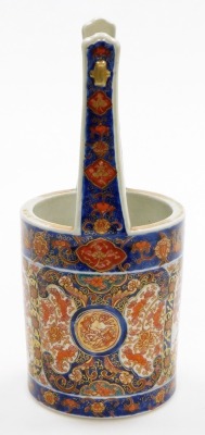 A 19thC Japanese Imari porcelain vase shaped as a well bucket, decorated with panels of trees, scrolls and shishi, signed to base, Meiji period, 30cm high. (AF) - 2