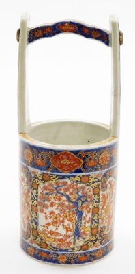 A 19thC Japanese Imari porcelain vase shaped as a well bucket, decorated with panels of trees, scrolls and shishi, signed to base, Meiji period, 30cm high. (AF) - 3