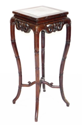 A late 19thC Chinese hardwood plant stand, the square top with marble inset, the splayed legs carved in imitation of bamboo, 92cm high, 36cm wide, 36 deep.