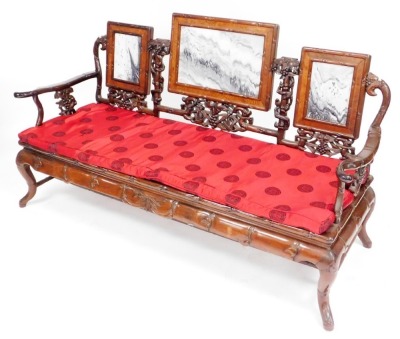 A Chinese hardwood three seater sofa, carved in imitation bamboo and inset with three marble panels to the back, ref brocade cushion, 92cm high, 71cm wide, 60cm deep.