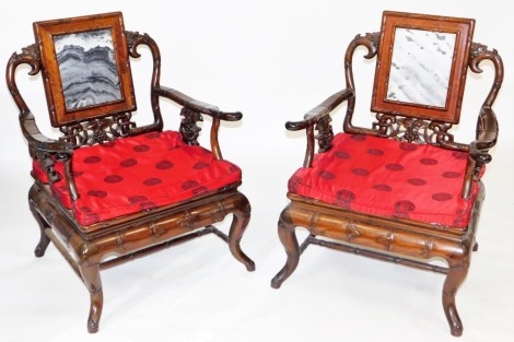 A pair of Chinese hardwood armchairs, carved in imitation of bamboo and inset with three marble panels to the back, ref brocade cushions, 97cm high, 67cm wide, 52cm deep. (2)