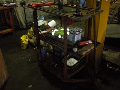 The residual contents of workshop. To include three steel work benches, two filing cabinets, vintage welder, quantity of alloy wheels, vintage tyre remover, pipe bender, carriage jack, bottle jacks, coopered barrel, AA directional marker signs, heavy dut - 8