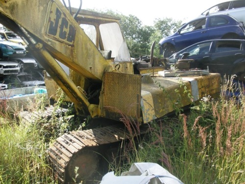 A JCB 5C digger with claw grab