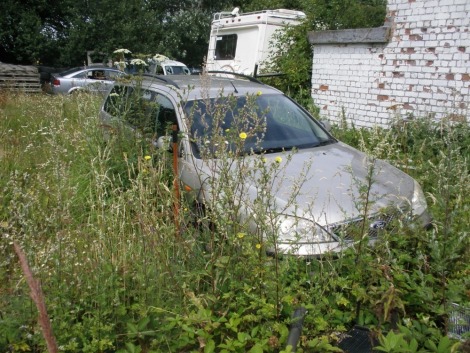 A group of five scrap vehicles. Peugeot 207 SW, registration KW07 PXX, Mondeo LX Estate, registration NV53 MHY, Vauxhall Corsa CDTI, FN05 VWA, Kia Rio LE, registration GU05 JEO, Chevolet Tacuma, registration YT07 NDF.