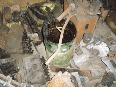 Vintage and collectors car engine parts, comprising of mostly cylinder heads for Ford and others, some heater motors and a box of carbs and manifolds. All situated in rear room on the floor.