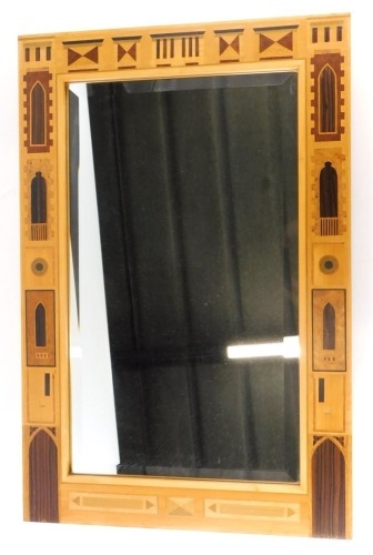 A David Lindley wall mirror, with a bevel plate, the frame with parquetry inlay of windows of differing designs, doorways, etc., in various specimen timbers, impressed factory mark and dated 1990 to the side, 76cm wide, 50cm wide.