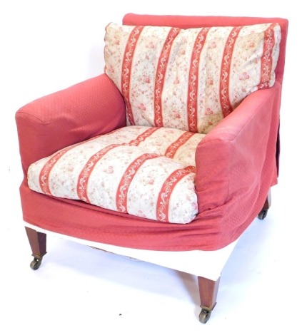 A late Victorian Howard & Sons mahogany armchair, with loose covers above calico ticking, maker's stamp to castors, back legs and hessian beneath, 73cm high, 66cm wide.