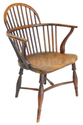 A 19thC yew, ash and elm Windsor chair, with a low hooped back, solid seat and turned legs with crinoline stretcher. (AF)