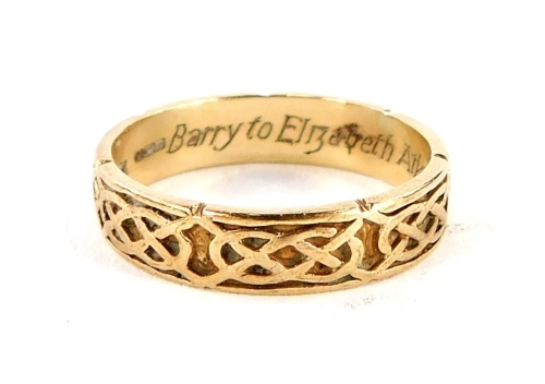 A 9ct gold wedding band, with cross and weaved design, internal inscription Barry to Elizabeth Atkinson 20-03-2005 eternal love and devotion, ring size M½, 2.4g. (boxed)