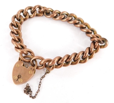 A 9ct gold charm bracelet, with heavy curb links, on a heart shaped padlock with safety chain, stamped 9c, 20cm long, 18g.