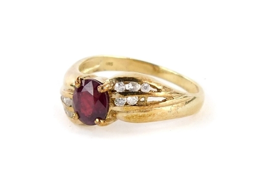 A dress ring, with central oval red paste stone with cz set shoulders, on a gold coloured band stamped 925, ring size N, 2.4g all in.