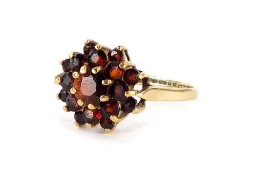 A 9ct gold floral cluster ring, set with three tiers of round brilliant cut garnets, in claw setting, ring size Q½, 2.5g all in. (boxed)