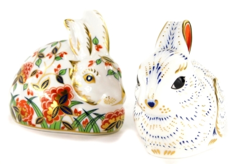 Two Royal Crown Derby porcelain bunny paperweights, Meadow Rabbit, exclusive for Royal Crown Derby Collectors Guild, with gold coloured stopper and a bunny paperweight for an exclusive Royal Crown Derby Collectors Guild, with gold coloured stopper, boxed.