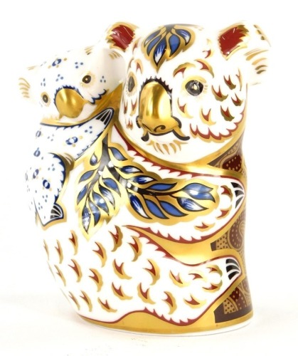 A Royal Crown Derby porcelain koala and baby paperweight, for the Australian collection, with gold coloured stopper, 10cm high, boxed.
