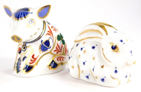 Two Royal Crown Derby porcelain paperweights, to include baby rabbit, with silver stopper, 6cm long, and sitting piglet, with gold coloured stopper, 6cm high.