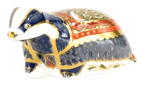 A Royal Crown Derby porcelain paperweight of Moonlight badger, for Royal Crown Derby Collectors Guild, with gold coloured stopper, 15cm long, boxed.