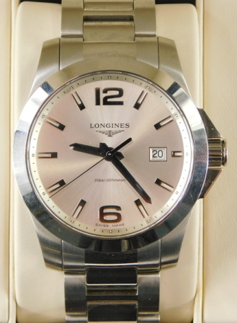 A Longines gentleman's wristwatch in stainless steel, having silvered sun ray dial with applied coffin and Arabic numeral markers with date aperture to three o'clock, upon a brushed stainless steel bracelet with associated box and paperwork, dial size is 