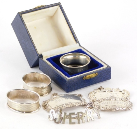 A collection of small silver and silver plated items, to include a pair of napkin rings with engine turned decoration, with initialled monograms, a further silver napkin ring, decanter labels to include Whisky, Sherry, Port, etc., weighable silver 2oz.