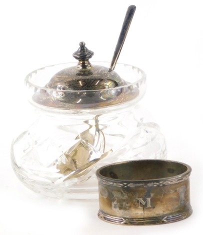 A George V cut glass and silver topped jam or condiment pot, with a silver spoon, Sheffield 1931, and a napkin ring. (3)