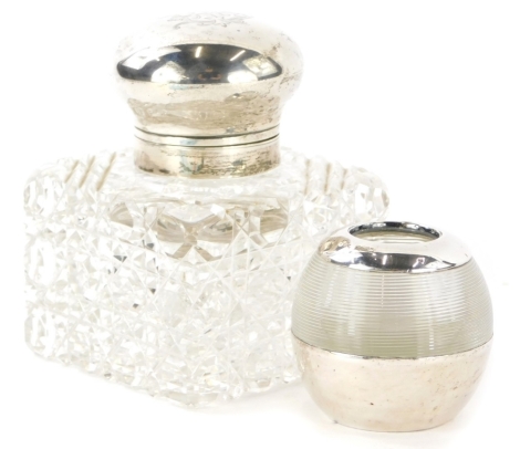 An Edward VII cut glass and silver topped scent bottle, of square form, the silver lid engraved with initials MB, London 1903, weighable silver 1¾oz, and a glass match strike with silver mounts, (2).